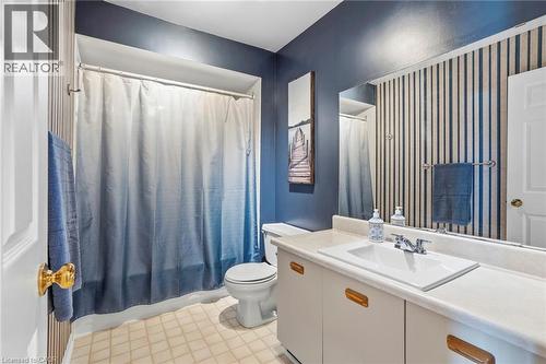 Bathroom with vanity, light flooring, and shower / bath combo with shower curtain - 18 Webster Way, Georgetown, ON - Indoor Photo Showing Bathroom