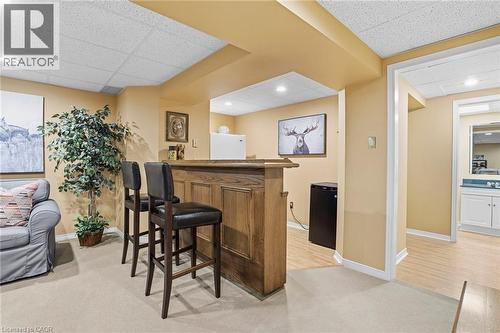 Indoor dry bar featuring light carpet, a drop ceiling, black refrigerator, and recessed lighting - 18 Webster Way, Georgetown, ON - Indoor