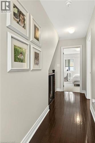 Hall with dark wood-style flooring and an upstairs landing - 1862 Burnhamthorpe Road, Mississauga, ON - Indoor Photo Showing Other Room