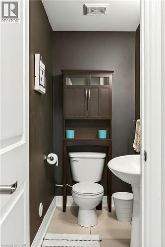 Half bath featuring toilet and light wood-type flooring - 1862 Burnhamthorpe Road, Mississauga, ON - Indoor Photo Showing Bathroom
