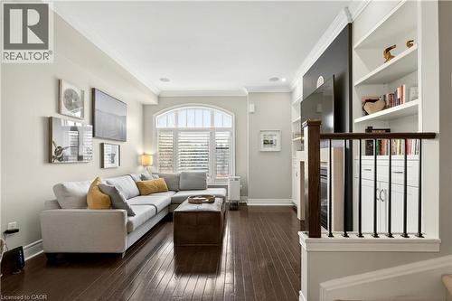 Living area featuring ornamental molding and dark wood-type flooring - 1862 Burnhamthorpe Road, Mississauga, ON - Indoor Photo Showing Other Room