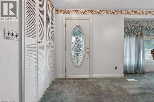 Entrance foyer with carpet flooring and baseboards - 21 Bluebird Avenue, Hamilton, ON - Indoor Photo Showing Other Room