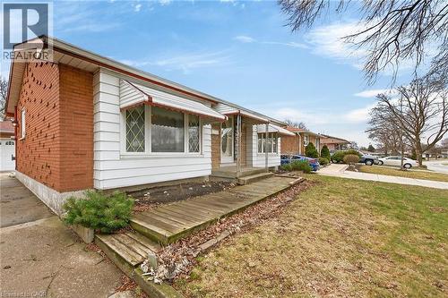 View of front facade with a front lawn and brick siding - 21 Bluebird Avenue, Hamilton, ON - Outdoor