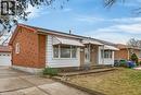 View of front facade with a front yard and brick siding - 21 Bluebird Avenue, Hamilton, ON 