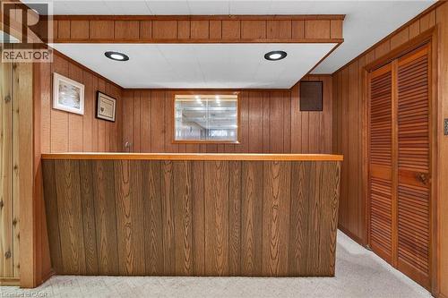 Bar with wood walls, recessed lighting, and light carpet - 21 Bluebird Avenue, Hamilton, ON 
