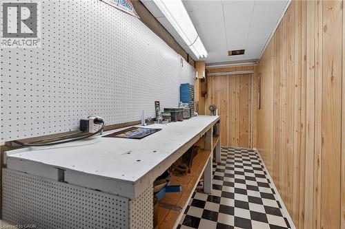 Office with dark floors, a workshop area, and wooden walls - 21 Bluebird Avenue, Hamilton, ON 