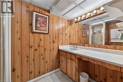 Full bathroom featuring wooden walls, a shower stall, and vanity - 21 Bluebird Avenue, Hamilton, ON 