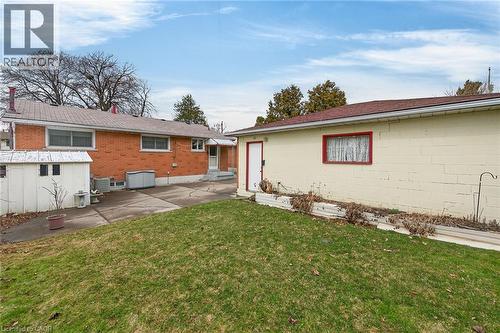 Back of property with a lawn and a patio - 21 Bluebird Avenue, Hamilton, ON 
