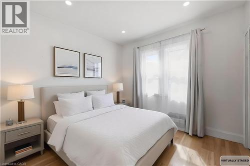 Bedroom with light wood finished floors and recessed lighting - 129 Jackson Street W, Hamilton, ON - Indoor Photo Showing Bedroom
