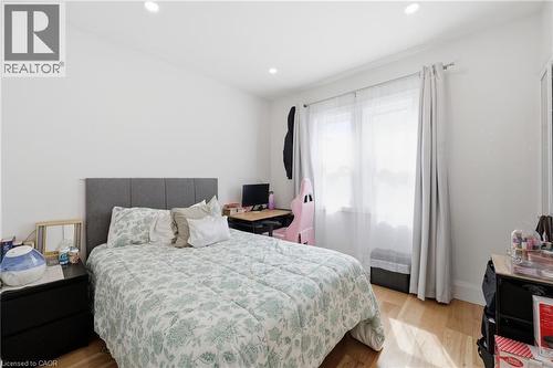Bedroom featuring light wood-style floors and recessed lighting - 129 Jackson Street W, Hamilton, ON - Indoor Photo Showing Bedroom