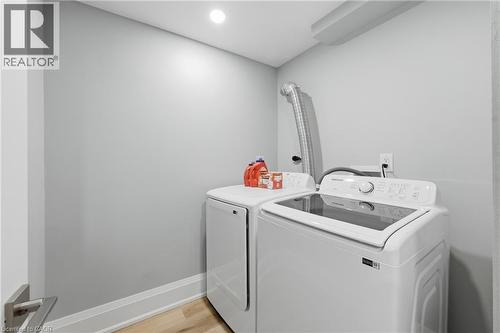 Laundry room with light wood finished floors, separate washer and dryer, and recessed lighting - 129 Jackson Street W, Hamilton, ON - Indoor Photo Showing Laundry Room