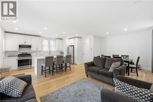 Living room with light wood finished floors and recessed lighting - 129 Jackson Street W, Hamilton, ON - Indoor Photo Showing Living Room