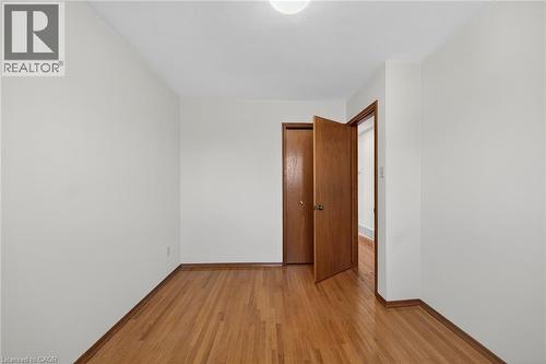 Unfurnished room with light wood-style flooring and baseboards - 122 Glen Forest Drive, Hamilton, ON - Indoor Photo Showing Other Room