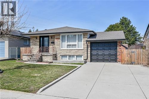 View of front of property with stone siding, a garage, a shingled roof, and driveway - 122 Glen Forest Drive, Hamilton, ON - Outdoor
