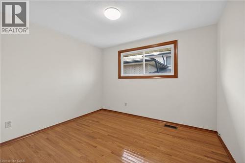 Empty room with light wood-style flooring and baseboards - 122 Glen Forest Drive, Hamilton, ON - Indoor Photo Showing Other Room