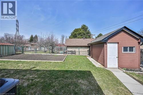 Fenced backyard with an outbuilding - 122 Glen Forest Drive, Hamilton, ON - Outdoor