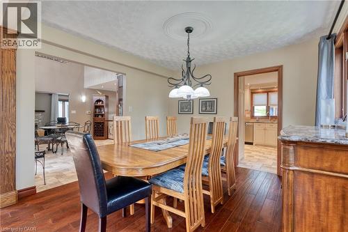 Dining room featuring dark wood-type flooring, a textured ceiling, and suspended lighting - 15 Marquette Drive, Kitchener, ON - Indoor Photo Showing Dining Room