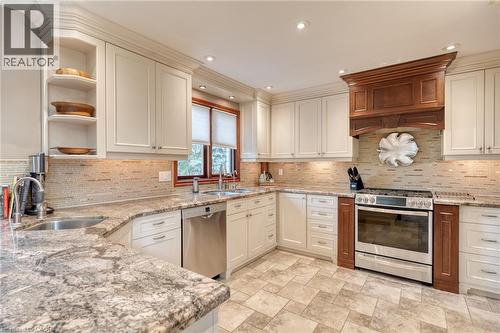 Kitchen featuring stainless steel appliances, open shelves, recessed lighting, light stone countertops, and decorative backsplash - 15 Marquette Drive, Kitchener, ON - Indoor Photo Showing Kitchen With Upgraded Kitchen