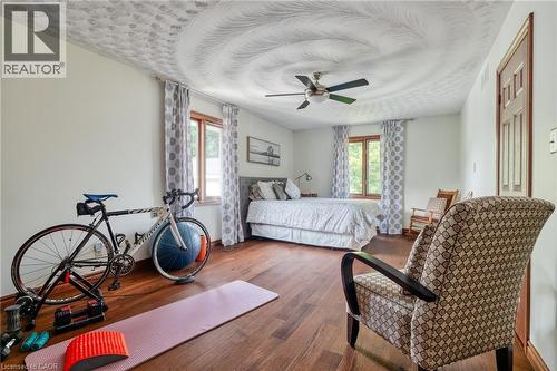 Bedroom featuring multiple windows, hardwood / wood-style floors, and a ceiling fan - 15 Marquette Drive, Kitchener, ON - Indoor Photo Showing Bedroom