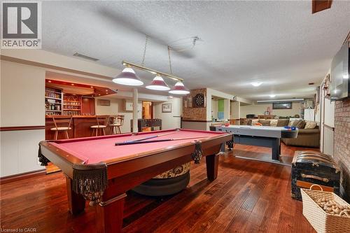 Rec room featuring billiards table, a textured ceiling, dark wood-style floors, and a wainscoted wall - 15 Marquette Drive, Kitchener, ON - Indoor Photo Showing Other Room