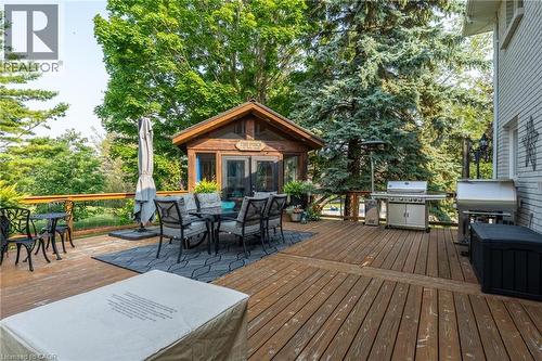 Deck featuring outdoor dining area, a grill, view of wooded area, and an outdoor structure - 15 Marquette Drive, Kitchener, ON - Outdoor With Deck Patio Veranda With Exterior