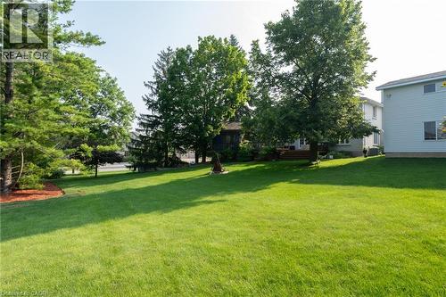 View of grassy yard with a deck - 15 Marquette Drive, Kitchener, ON - Outdoor