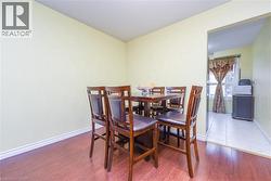 Dining room featuring wood finished floors and baseboards - 