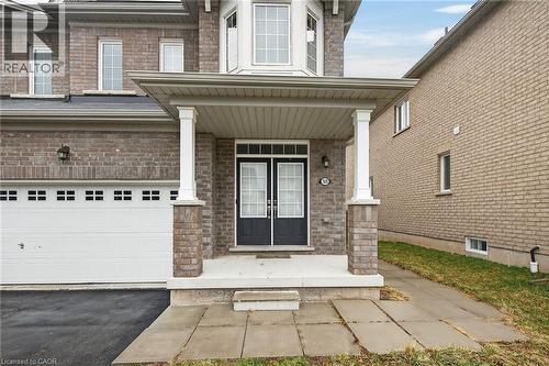View of exterior entry featuring a porch, brick siding, driveway, and an attached garage - 7809 Hackberry Trail E, Niagara Falls, ON - Outdoor
