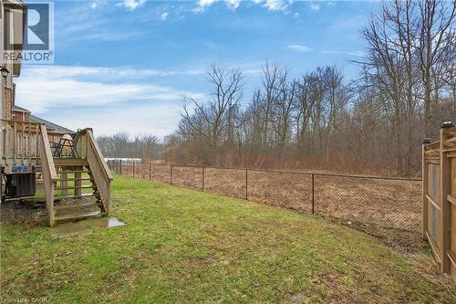 Fenced backyard featuring stairway and a wooden deck - 7809 Hackberry Trail E, Niagara Falls, ON - Outdoor
