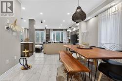 Dining room with crown molding, light marble finish flooring, and recessed lighting - 