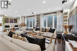 Living area featuring dark wood-style flooring and recessed lighting - 