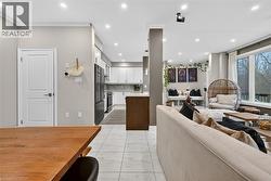 Living area featuring light marble finish floors, recessed lighting, and ornamental molding - 