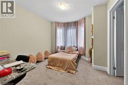 Bedroom featuring carpet and a textured ceiling - 