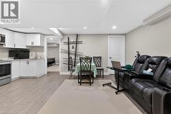 Living area featuring light wood-style floors and recessed lighting - 