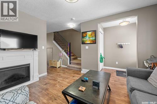 411 3826 Dewdney Avenue E, Regina, SK - Indoor Photo Showing Living Room With Fireplace