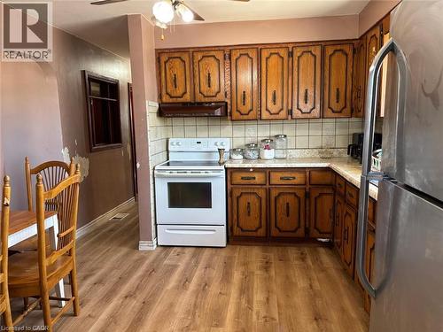 Kitchen with light countertops, arched walkways, freestanding refrigerator, electric range, and tasteful backsplash - 1224 Dunsmure Road, Hamilton, ON - Indoor Photo Showing Kitchen