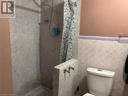 Bathroom featuring a stall shower and tile walls - 1224 Dunsmure Road, Hamilton, ON - Indoor Photo Showing Bathroom