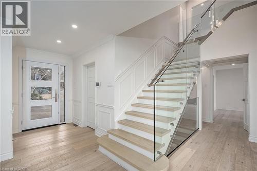 Foyer entrance featuring light wood-type flooring, recessed lighting, a decorative wall, and a wainscoted wall - 624 North Shore Boulevard E, Burlington, ON - Indoor Photo Showing Other Room