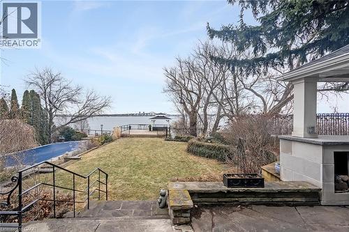 View of yard with a water view and a patio area - 624 North Shore Boulevard E, Burlington, ON - Outdoor