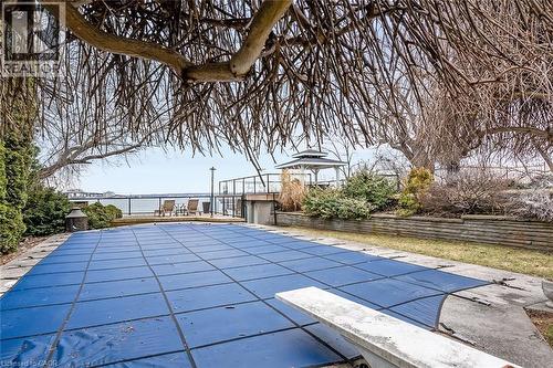 View of pool with patio surround and a diving board - 624 North Shore Boulevard E, Burlington, ON - Outdoor With In Ground Pool
