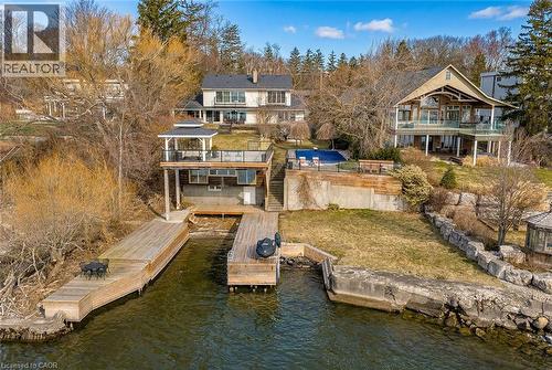 Back of house with a water view, a lawn, and a boat ramp - 624 North Shore Boulevard E, Burlington, ON - Outdoor With Body Of Water With Balcony With Deck Patio Veranda