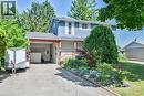 Traditional-style home with driveway, an attached carport, a front yard, and brick siding - 56 Forsythe Avenue, Brantford, ON  - Outdoor 