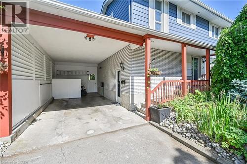 View of parking featuring concrete driveway and an attached carport - 56 Forsythe Avenue, Brantford, ON - Outdoor With Exterior