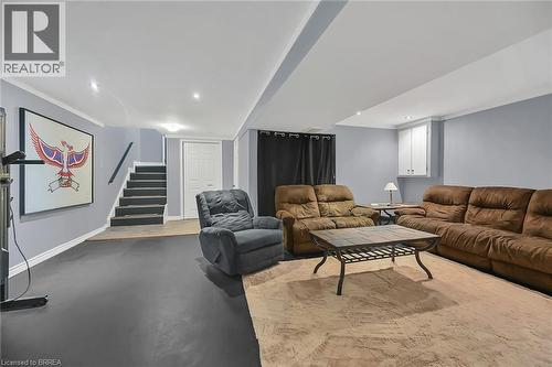 Living room featuring stairs and finished concrete floors - 56 Forsythe Avenue, Brantford, ON - Indoor Photo Showing Living Room