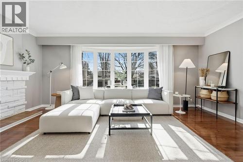 Living area with hardwood / wood-style flooring, crown molding, and a fireplace - 227 Walden Drive, Burlington, ON - Indoor Photo Showing Living Room
