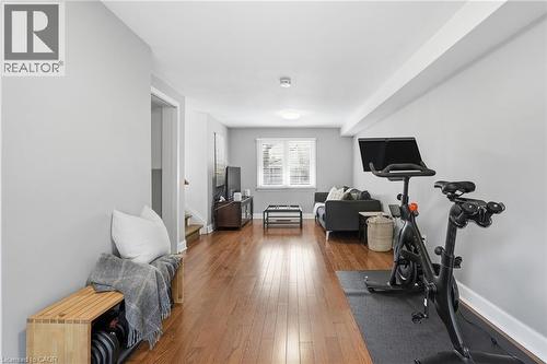 Workout area featuring dark wood-style flooring and baseboards - 227 Walden Drive, Burlington, ON - Indoor Photo Showing Gym Room