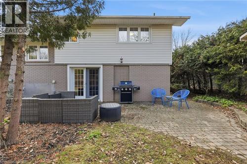 Back of house with a patio area, brick siding, and outdoor seating - 227 Walden Drive, Burlington, ON - Outdoor