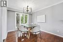 Dining area featuring ornamental molding, dark wood-type flooring, and a chandelier - 227 Walden Drive, Burlington, ON  - Indoor Photo Showing Dining Room 
