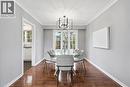 Dining area with dark wood finished floors, a chandelier, plenty of natural light, and crown molding - 227 Walden Drive, Burlington, ON  - Indoor Photo Showing Dining Room 