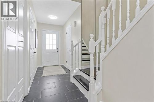 Foyer entrance with stairs and dark tile patterned flooring - 440 Langlaw Drive, Cambridge, ON - Indoor Photo Showing Other Room